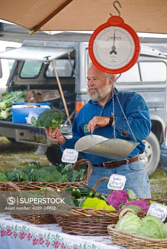 A vendor selling produce & flowers during summer at the Homer Farmer´s Market on Kenai Peninsula, Alaska