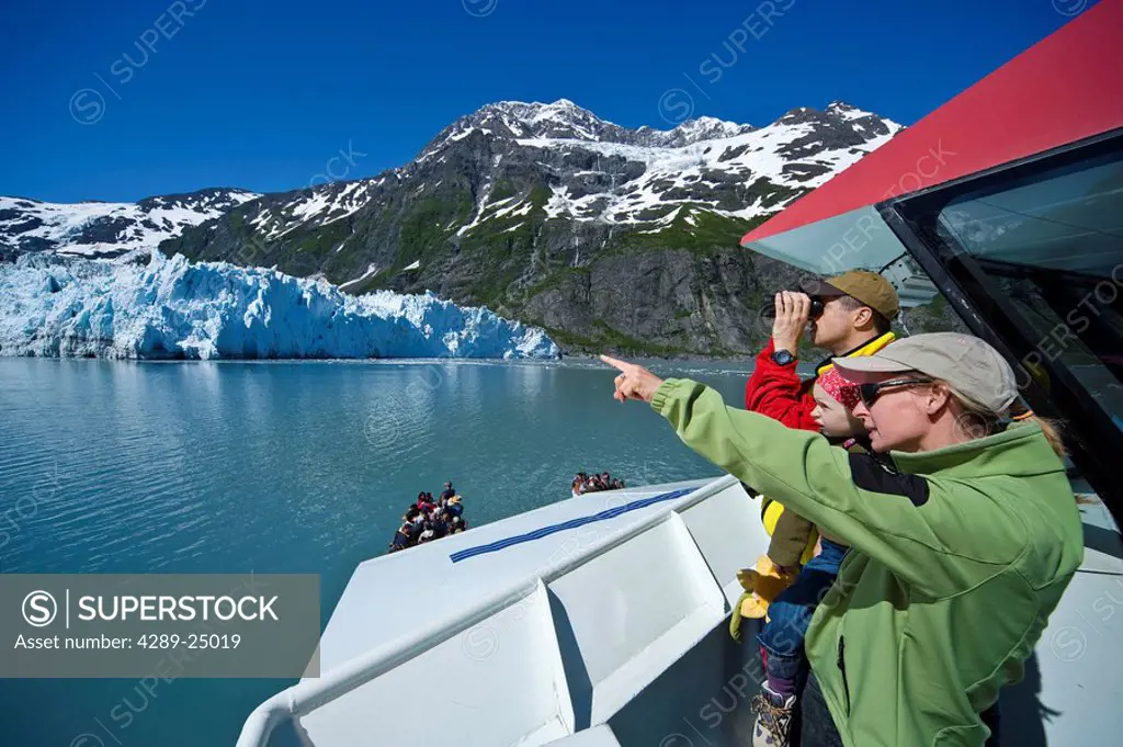 Family sight seeing in College Fjord from the deck of the Klondike Express tour boat, Prince William Sound, summer, South Central Alaska