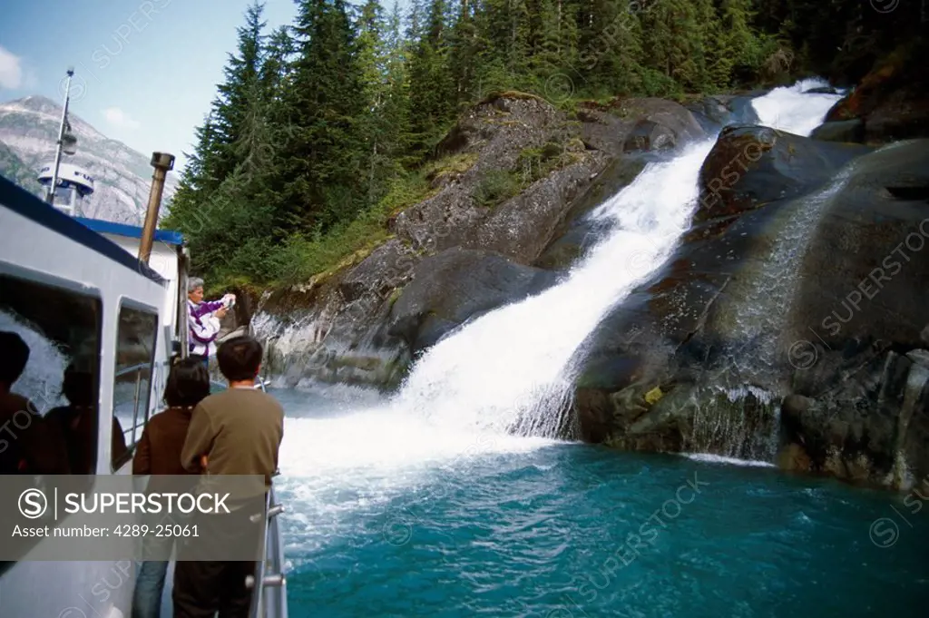 Visitors View Waterfall From Tourboat in Tracy Arm, Fords_Terror Wilderness Area, SE Alaska Summer