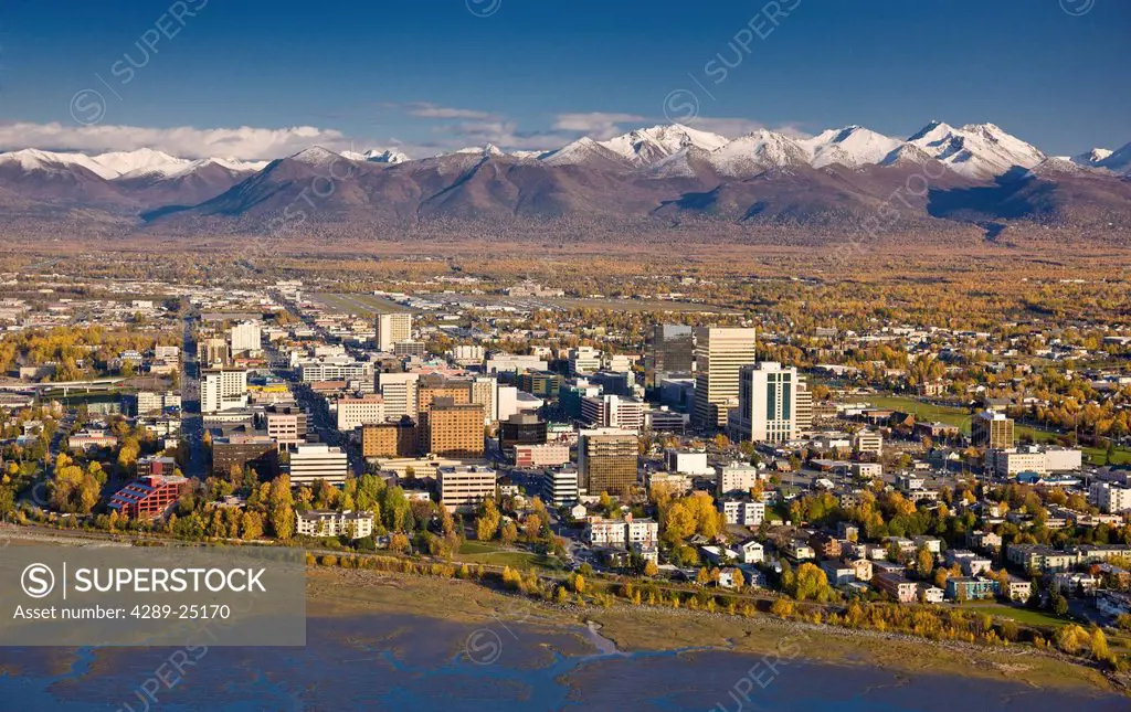 Aerial view of the Anchorage skyline looking south over Knik Arm with the Chugach Mountains in the background during Fall, Southcentral Alaska
