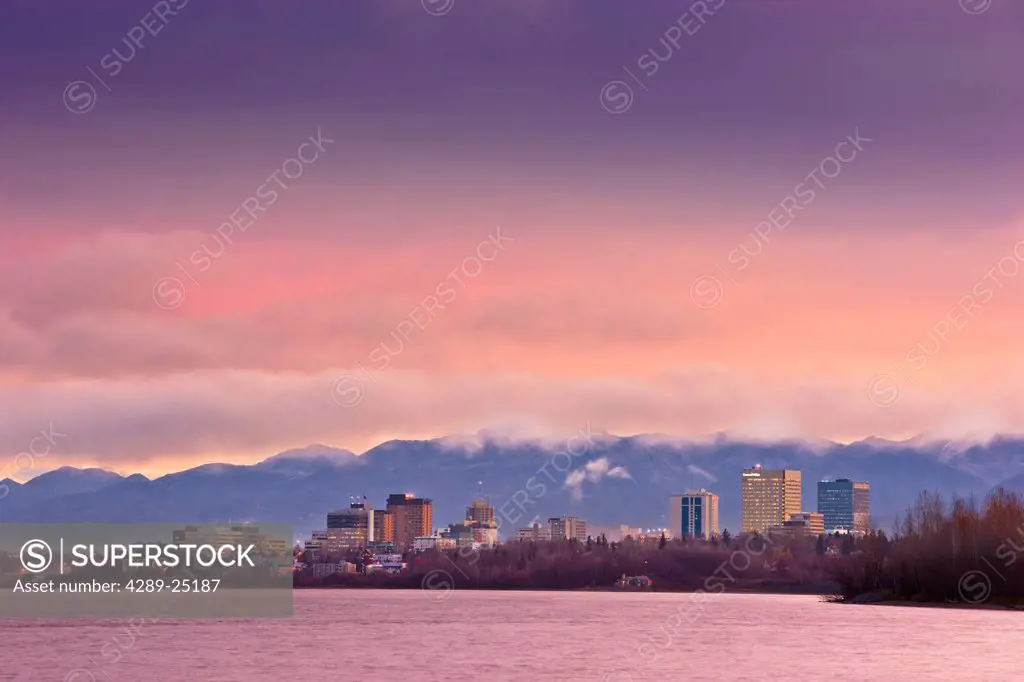 Skyline view of the sun rising over a fog shrouded Anchorage and Cook Inlet, Southcentral Alaska, Fall