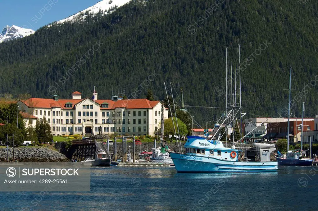 A commercial fishing boat passes in front of the pioneer home in downtown Sitka, Alaska
