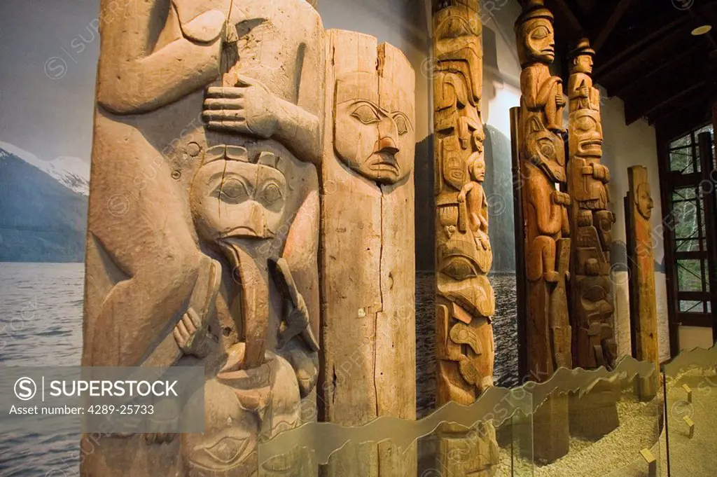 Historical totem poles on display inside Sitka National Historical Park building Sitka Alaska