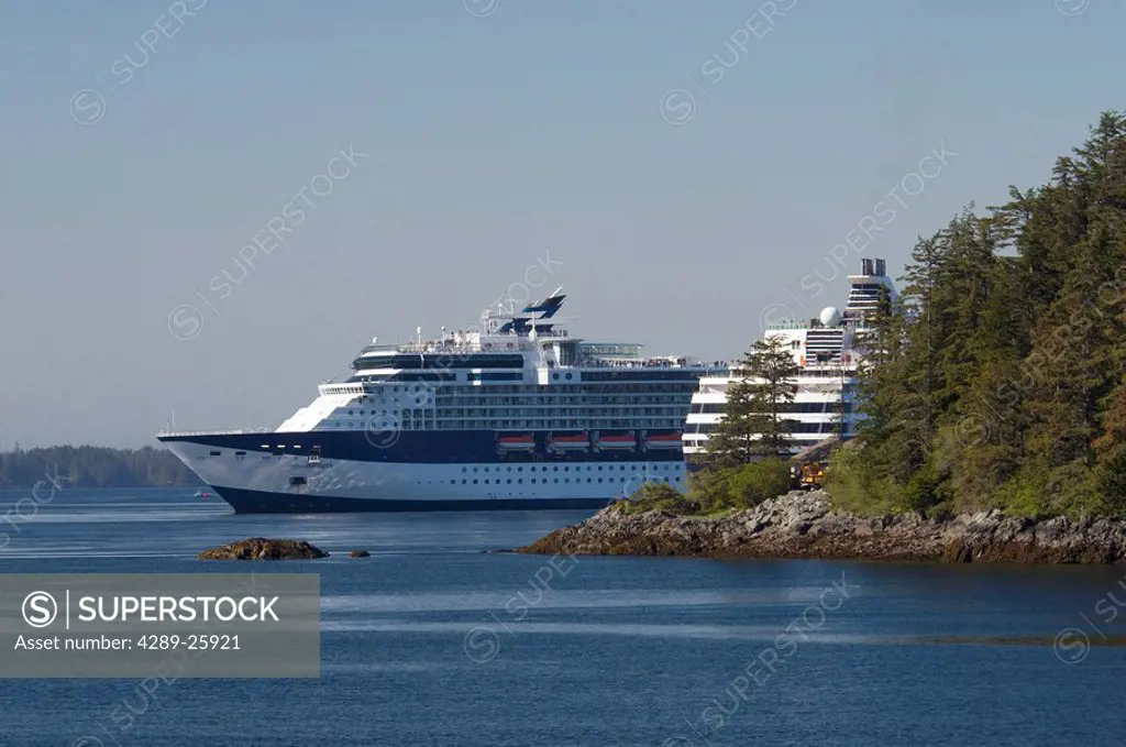 Celebrity Cruise ship Infinity and Holland America cruise ship Veendam pass by each other near Sitka, Alaska during Summer