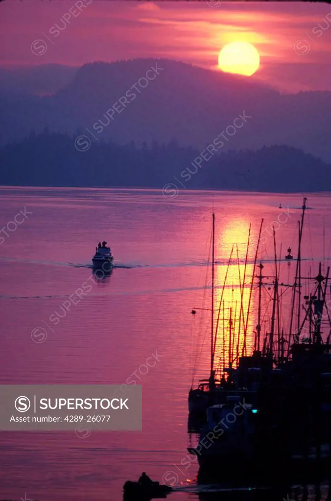 Pleasure boat heads to dock Sitka Sound Southeast AK sunset summer scenic