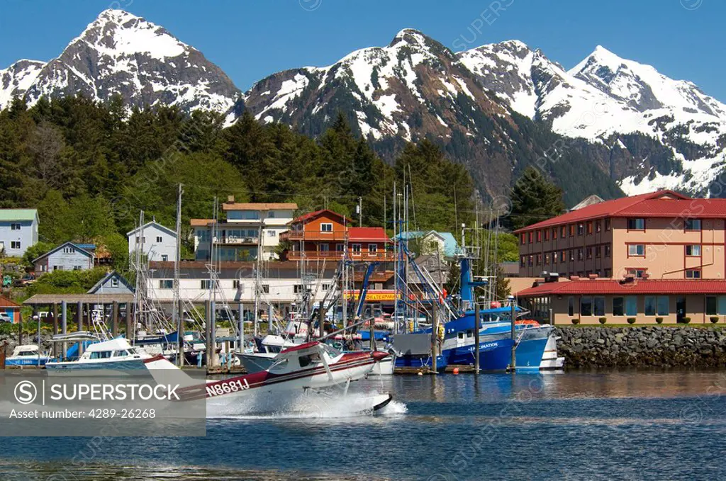 Rloatplane takes off from the waterfront in Sitka, Alaska