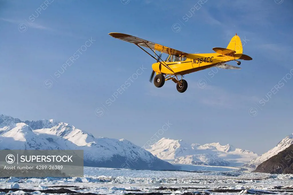 Piper Super Cub flying over Knik & Colony Glacier Matsu Valley Chugach Mountains Southcentral Alaska Summer