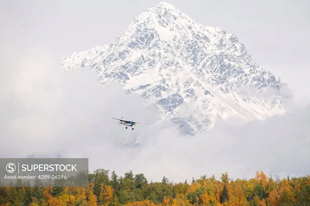 Airplane approaching Palmer Municipal Airport with Granite Peak in background,/nSouthcentral, Alaska, Fall