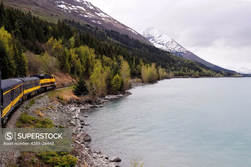 The Alaska Railroad´s Coastal Classic train travels past Kenai Lake on its way to Seward during the day, Kenai Peninsula, Southcentral Alaska, Summer