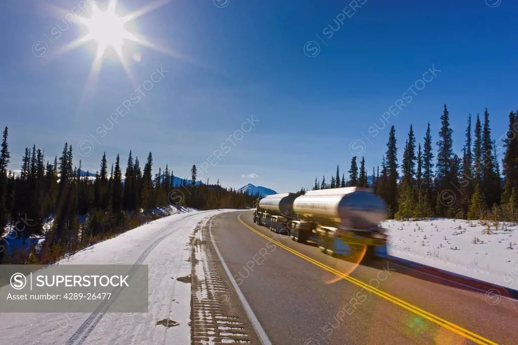 Semi_truck hauling tankers on the George Parks Highway close to the Denali National Park and Preserve entrance, Interior Alaska, Winter