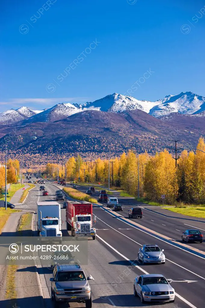 Traffic on Tudor Road looking east towards the Chugach Mountains during Autumn, Anchorage, Southcentral Alaska