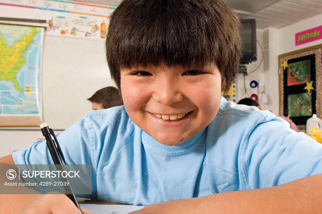 Alaskan native boy in classroom at desk inside Alaska