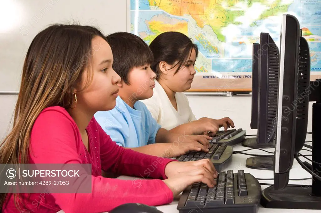 Alaskan Native children in classroom working at computers Alaska