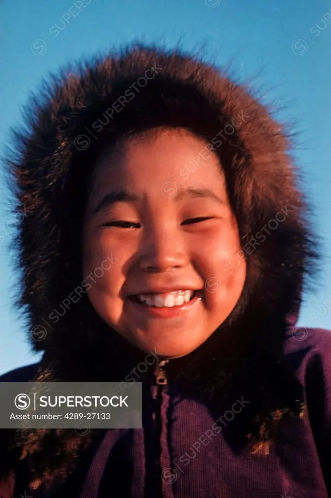 Portrait of smilling Inupiat Eskimo boy with fur trimmed hood around his face Barrow Alaska