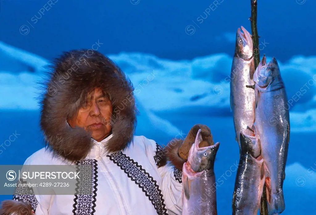 Eskimo Man with Salmon Icebergs in background AK winter portrait