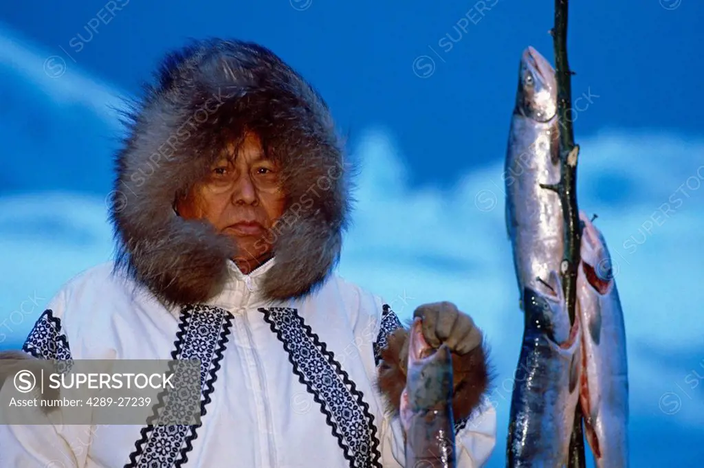 Eskimo Man with Salmon Icebergs in background AK winter portrait