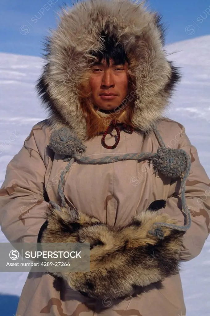 Portrait of Inupiat Eskimo man in Wolf ruff Parka Buckland Alaska Western Spring