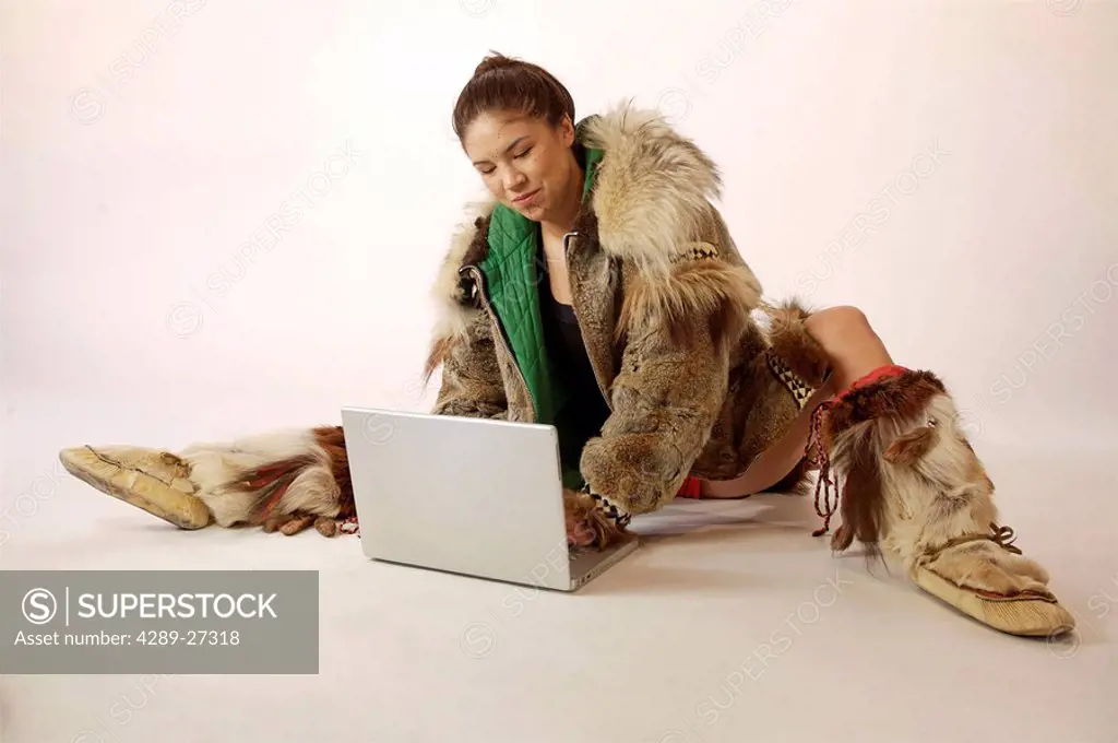 Native Alaskan Inupiat Woman in Wolf Fur Coat in Studio w/ laptop computer