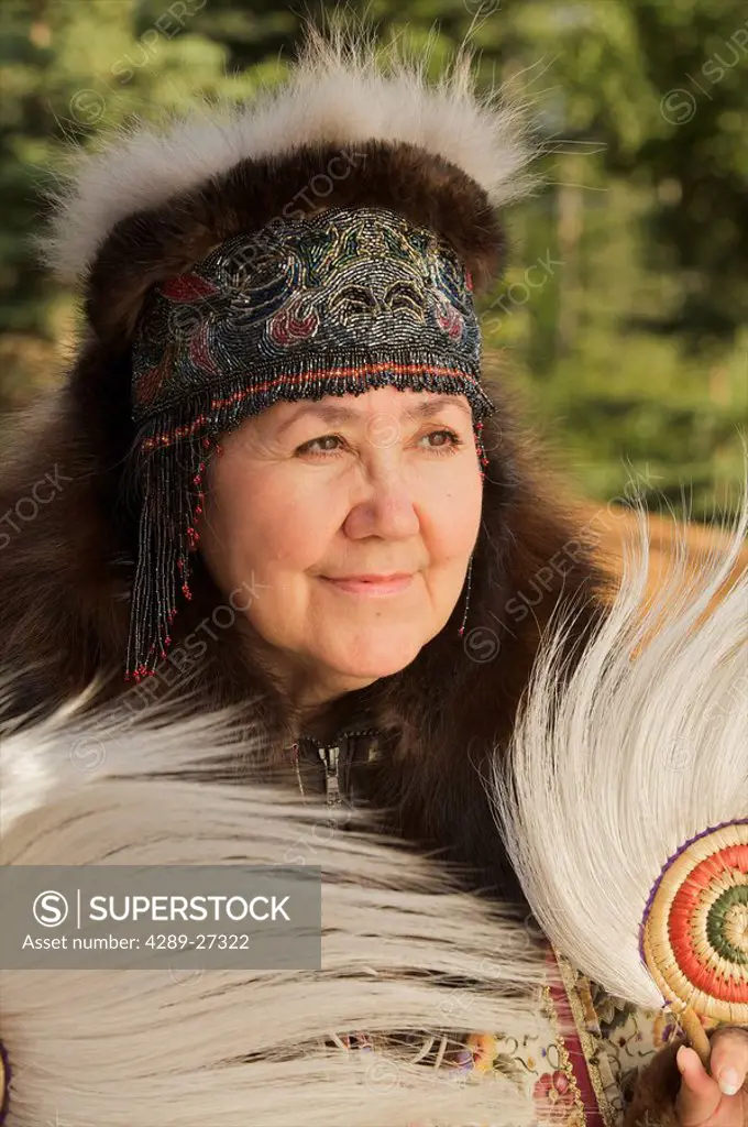 Portrait of a Yup´ik woman with beaded headdress and tradtional dancing fans, Alaska