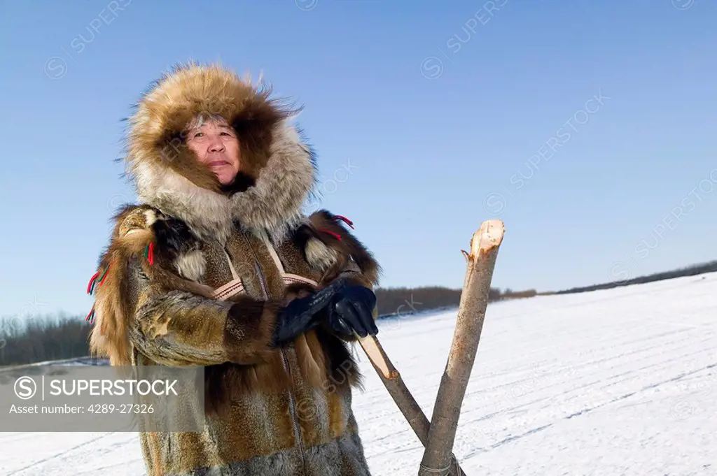 Female Yupik elder in traditional fur parka she made on frozen Kuskokwim River Akiachak Alaska