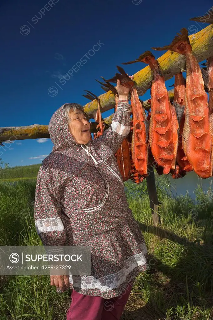Portrait of elder native Yupik woman near fish drying rack Kuskokwim River Akiachak Western Alaska