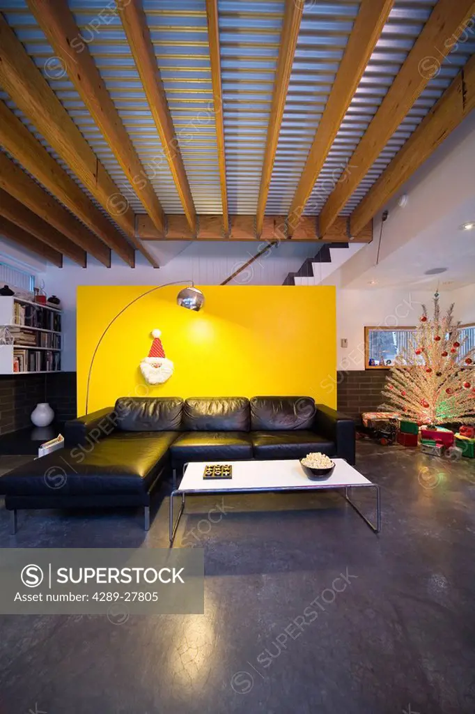 Modern style living room decorated for the Christmas holidays with bright yellow wall winter Alaska