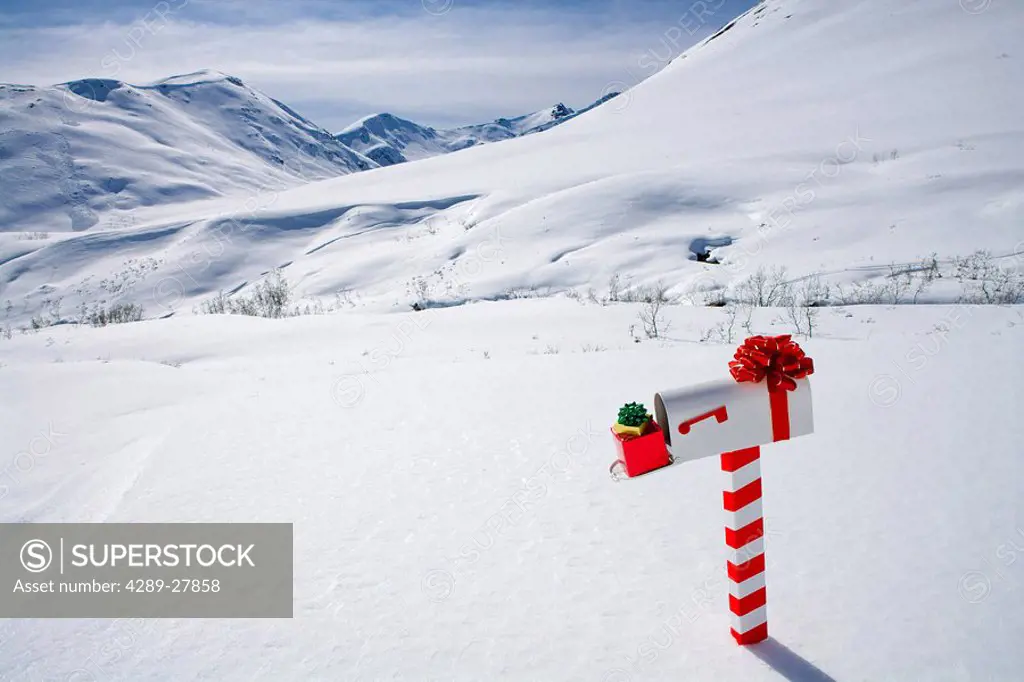White mailbox decorated for Christmas standing in the snow Winter Hatcher Pass Southcentral Alaska