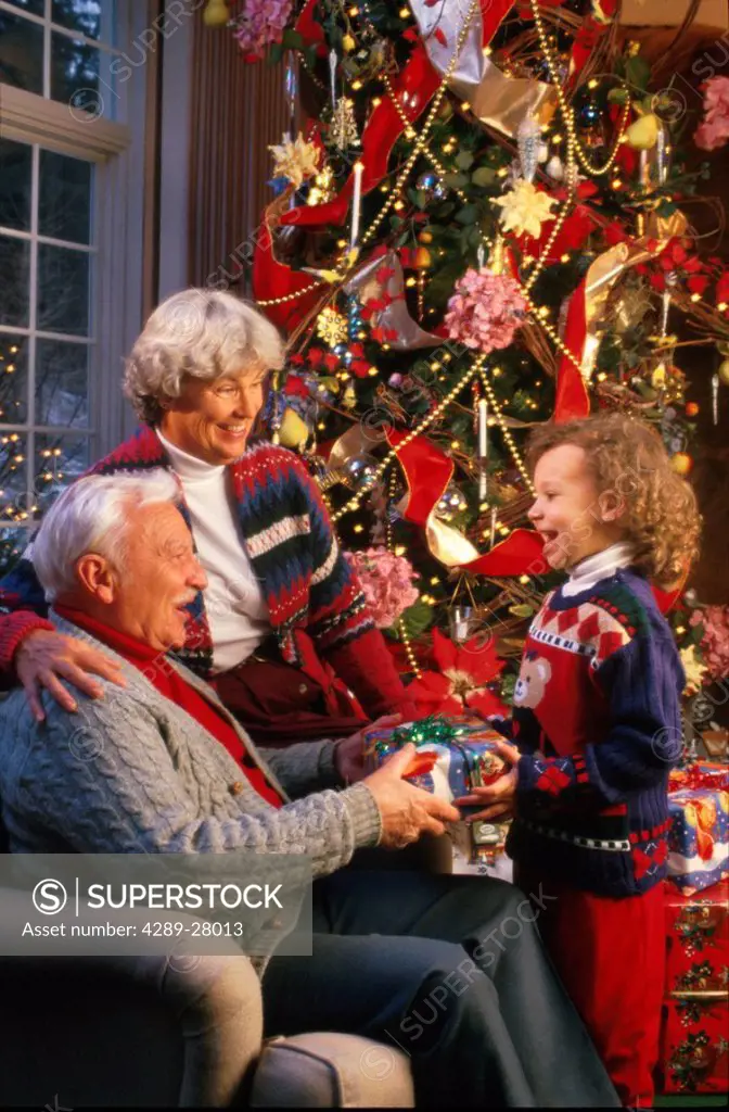 Grandparents recieve present from grandchild / Christmas