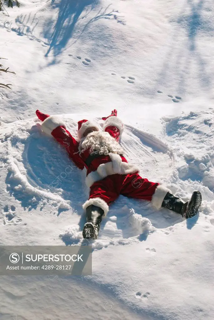 Santa making a snow angel in fresh snow