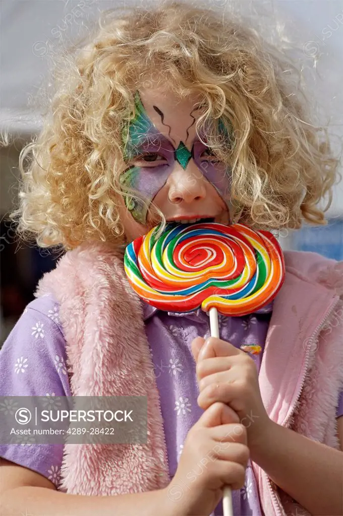 Young girl with lollipop at Alaska State Fair Matanuksa Valley Southcentral Alaska