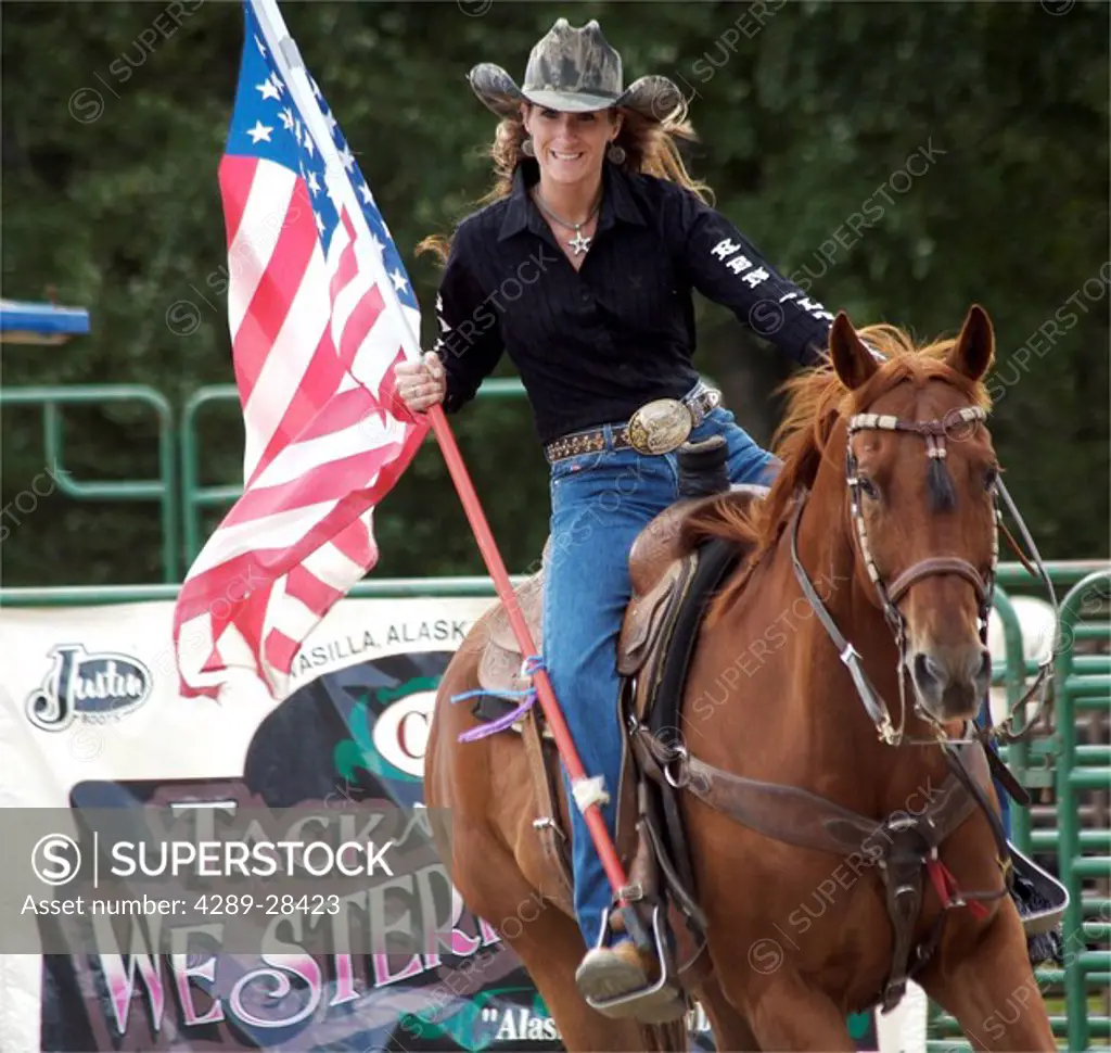 Woman on horseback with US flag at Alaska State Fair Palmer Alaska