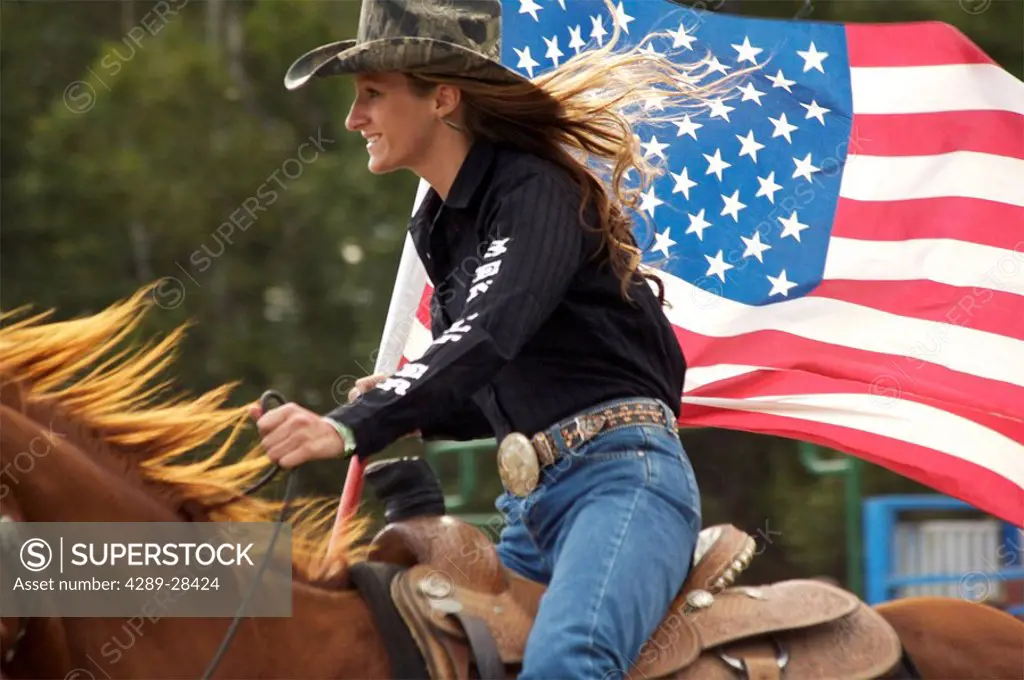 Woman on horseback with US flag at Alaska State Fair Palmer Alaska