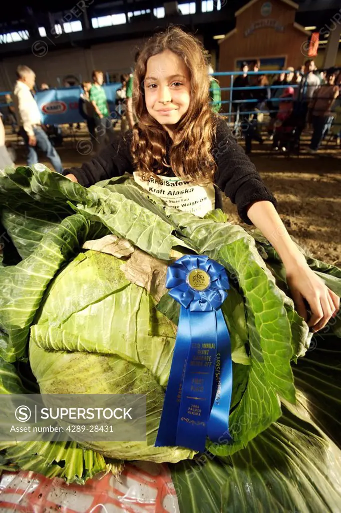 Young girl with first place giant cabbage at Alaska State Fair Palmer Alaska
