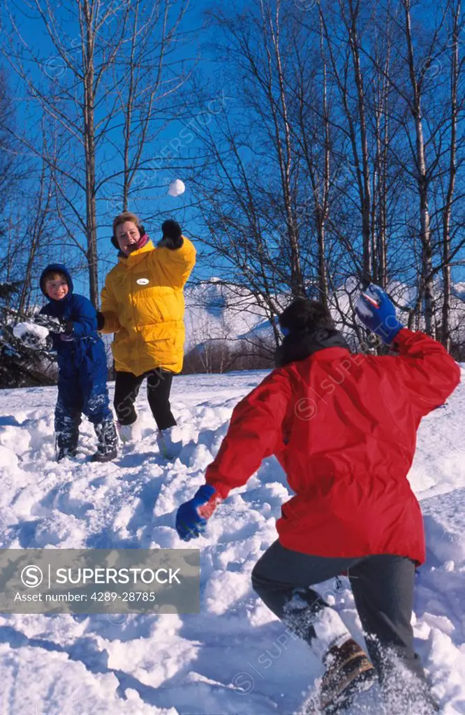 Family throwing snowballs Russian Jack Park Anchorage SC AK winter scenic