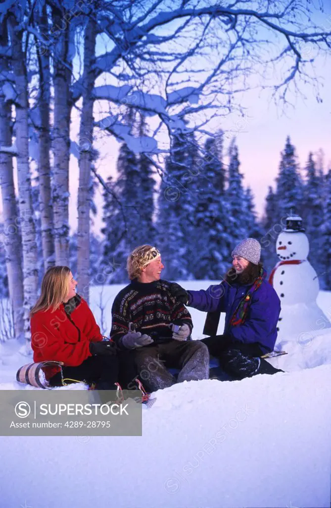 People Relax After Playing in the Snow Winter SC AK Snowman & Toboggan
