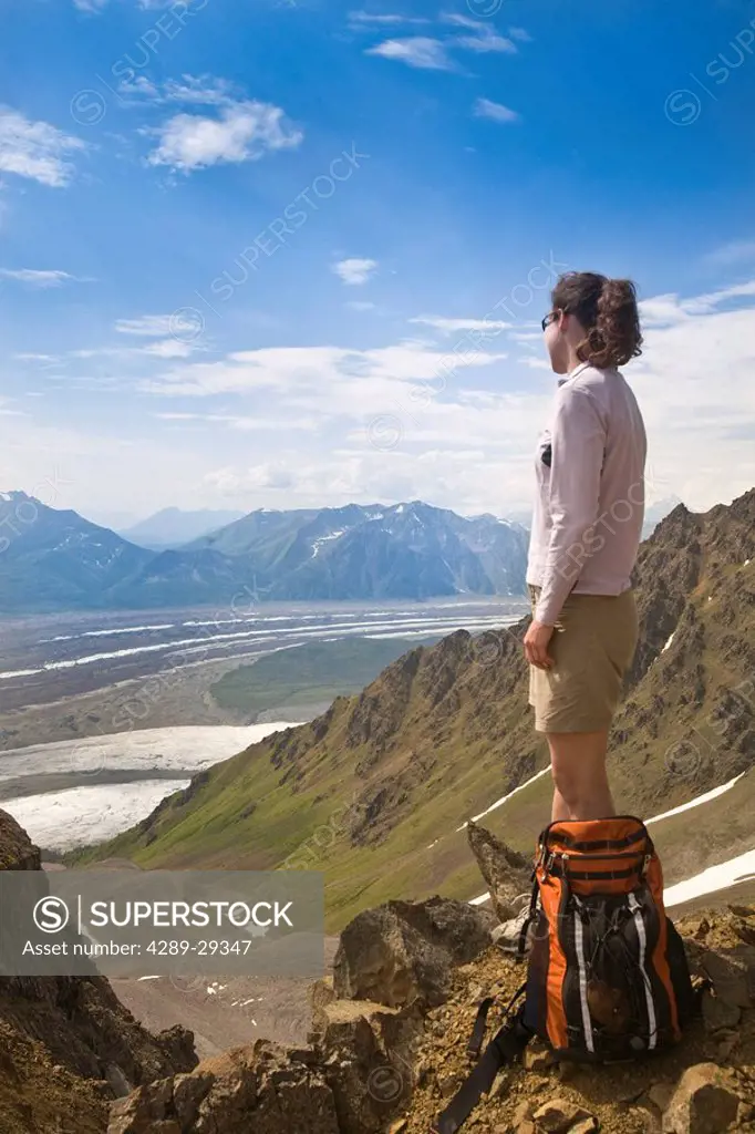 Woman standing on ridge overlooking the Root and Kennicott glaciers in Wrangell_St. Elias National Park, Alaska