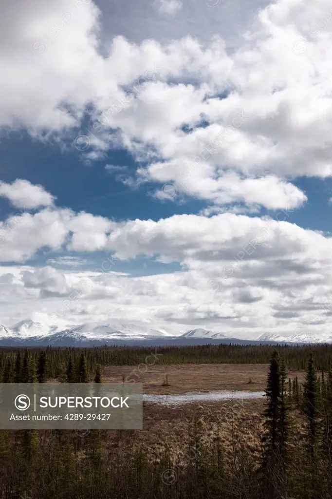 Clouds over Kenai Range with spring ice on marshy wetlands, Southcentral Alaska
