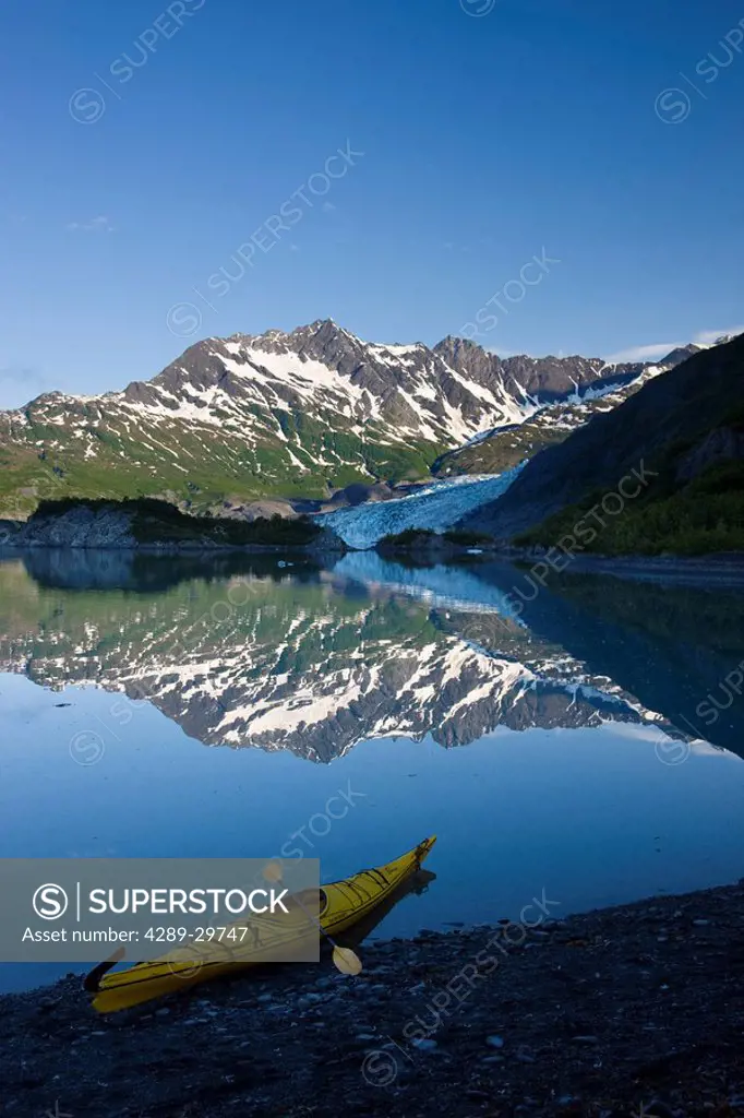 Kayak on the beach in Shoup Bay with Shoup Glacier reflected in the water, Prince William Sound, Southcentral Alaska