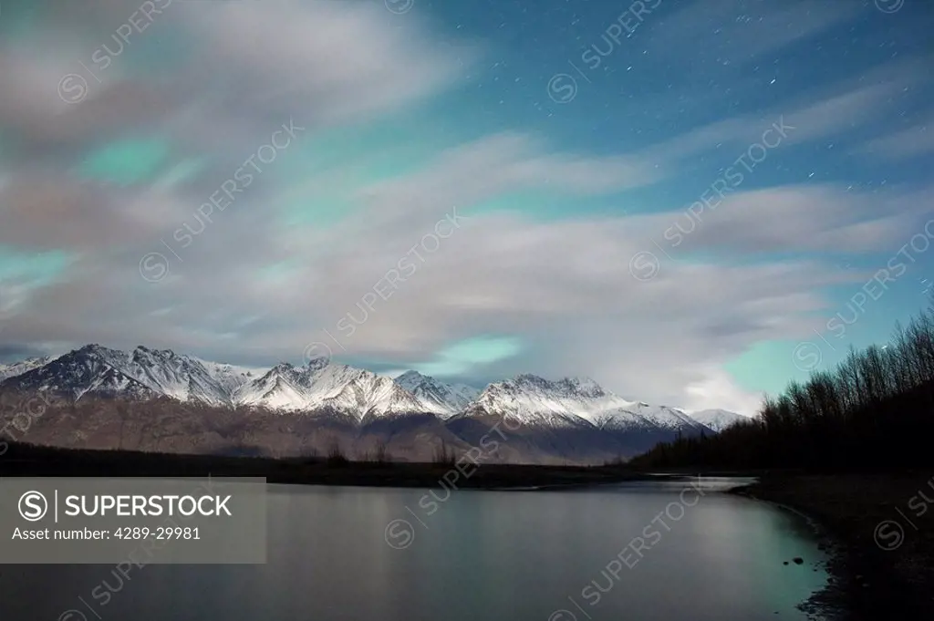 A long exposure of fast moving clouds moonlit night, Knik River Valley, Chugach Range, Southcentral Range, Alaska, Fall