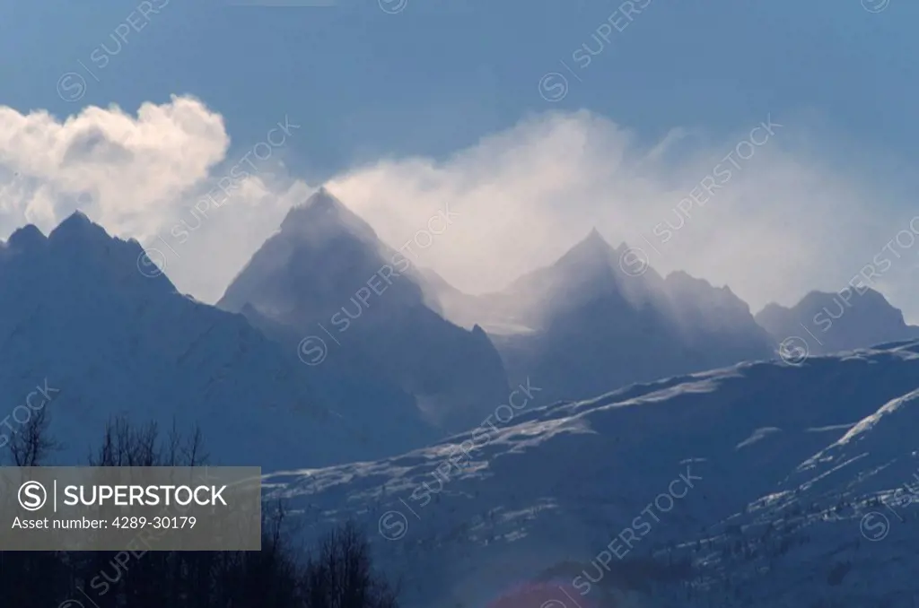 Blowing snow from peaks of mountains near Valdez Alaska