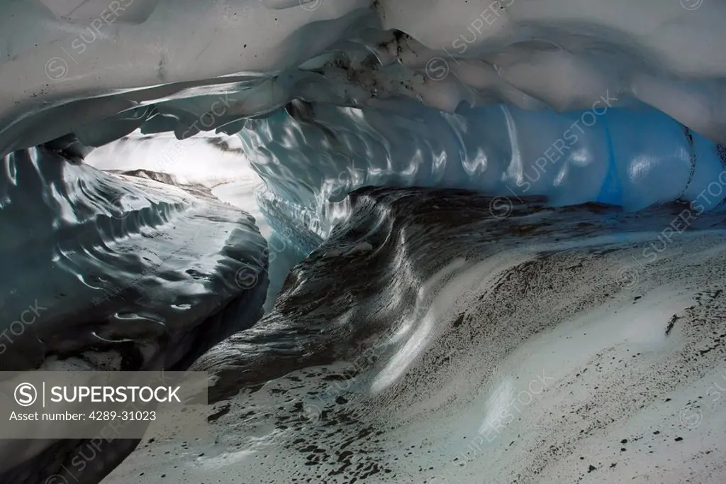 Stream cut tunnel and scalloped walls formed by wind on the Matanuska Glacier in the spring, Southcentral Alaska