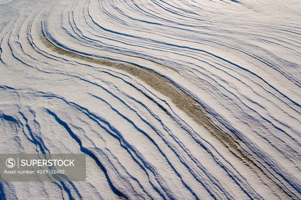 Windswept snow patterns on frozen Mendenhall Lake Southeast Alaska Winter