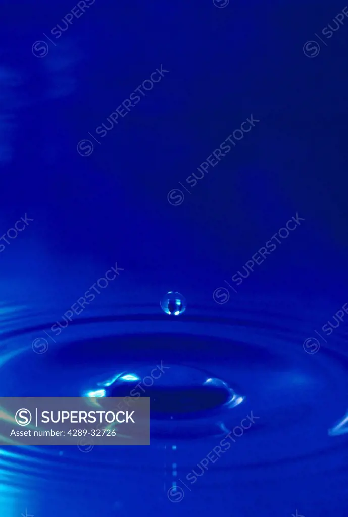 Water drop dropping in pool detail / blue
