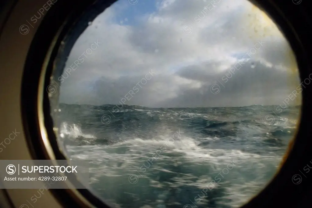 View of rough seas out porthole of M/V Endeavor in South Atlantic Summer