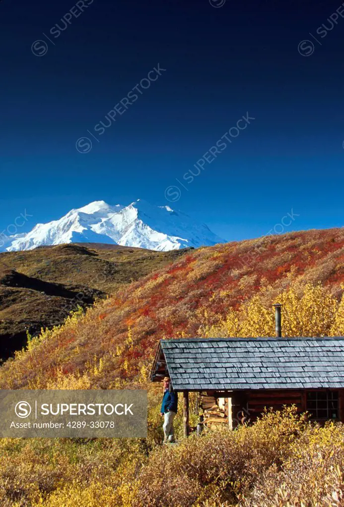 Person on porch of log cabin Mt McKinley Denali NP Int AK fall scenic