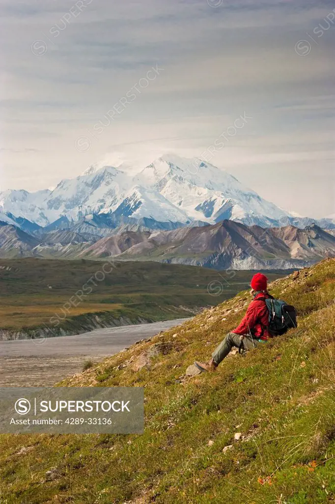 Female hiker views Mt. McKinley in Denali National Park, near Eielson Visitors Center, Interior Alaska, Fall