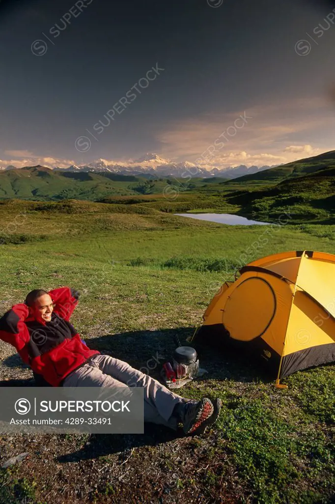 Man Relaxes in Camp on Peters Hill Denali SP SC AK Summer