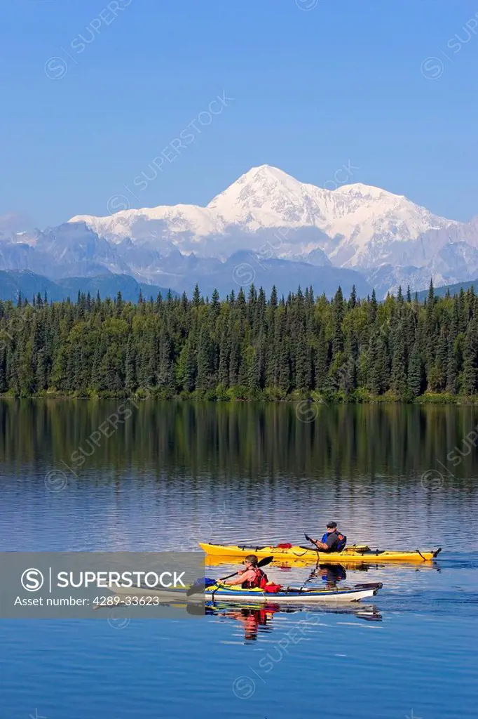Pair of kayakers on Byers lake with Denali in the background Summer Interior Alaska