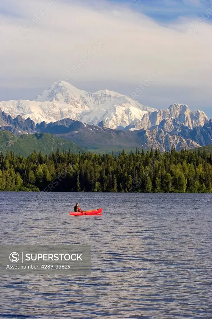 Man Canoeing on Byers lake with Denali in the background Southcentral Alaska Summer