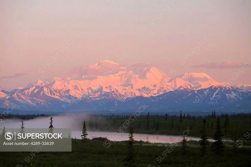 Mt. Mckinley reflected in small Lake at sunrise in Broad Pass, Alaska Range, Denali National Park, Alaska